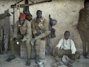 Senegalese soldiers serving in the French Army as infantrymen resting in a room with guns and equipment, Saint-Ulrich, Department Haut-Rhin, Alsace, France, June 16, 1917